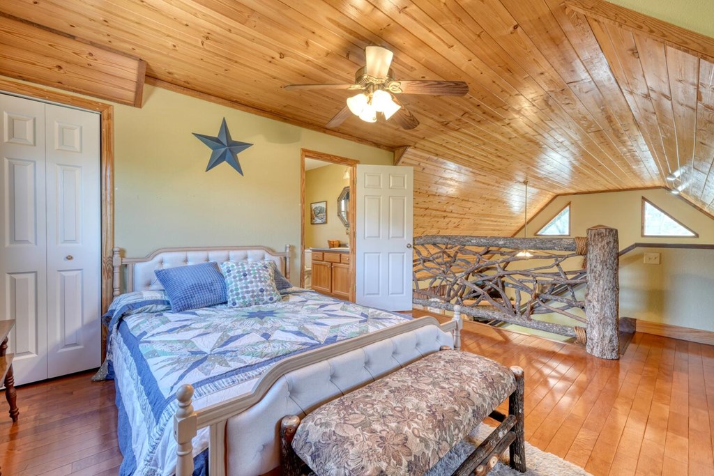 4852 Hf Lyons Road Hiawassee, GA 30546 - Photo 27 of 48 a living room with a couch and wooden floor