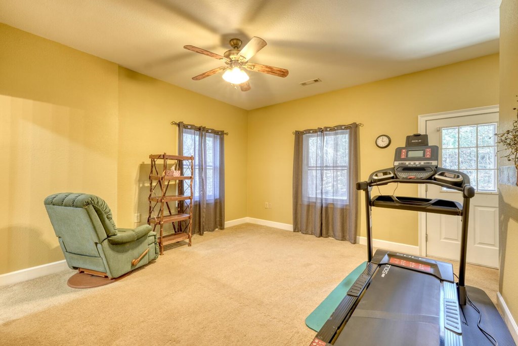 4852 Hf Lyons Road Hiawassee, GA 30546 - Photo 32 of 48 a bedroom with a bed a chair and potted plant on the dresser