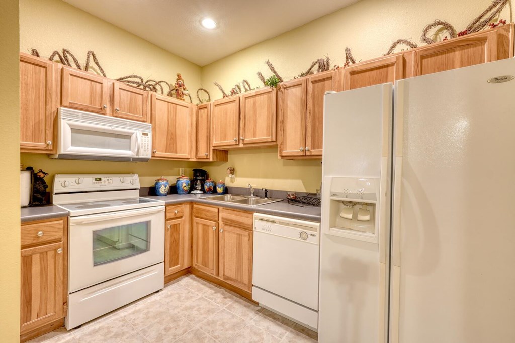 4852 Hf Lyons Road Hiawassee, GA 30546 - Photo 33 of 48 a kitchen with stainless steel appliances a refrigerator sink and cabinets