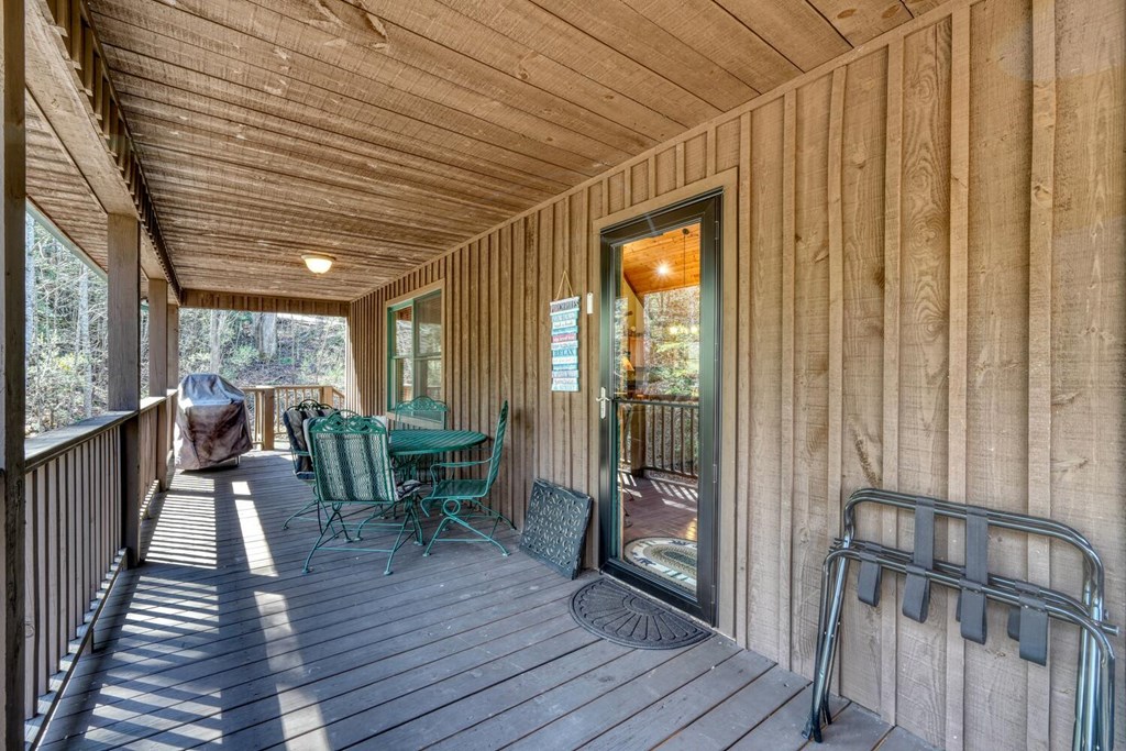 4852 Hf Lyons Road Hiawassee, GA 30546 - Photo 41 of 48 a balcony with chairs and wooden floor