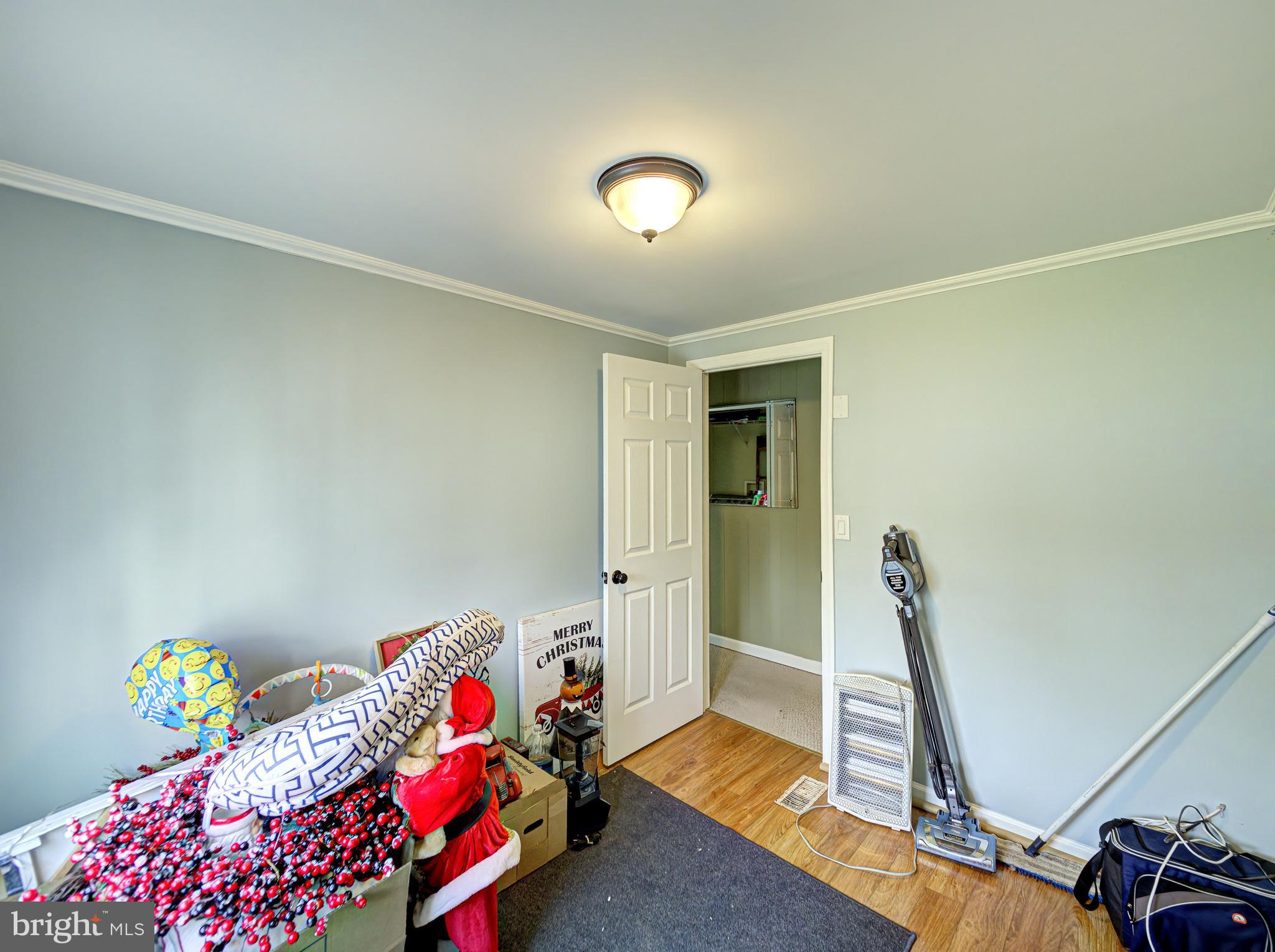 59 Bayshore Mobile Manor Hazlet, NJ 07730 - Photo 14 of 22 a bedroom with a bed and a chandelier