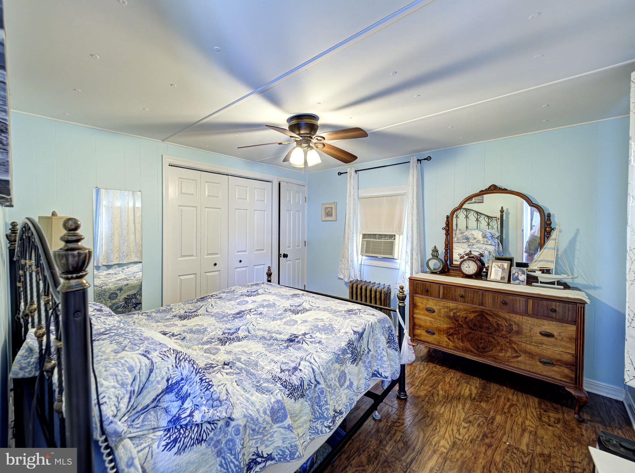 59 Bayshore Mobile Manor Hazlet, NJ 07730 - Photo 18 of 22 a bedroom with a bed and a dresser in it