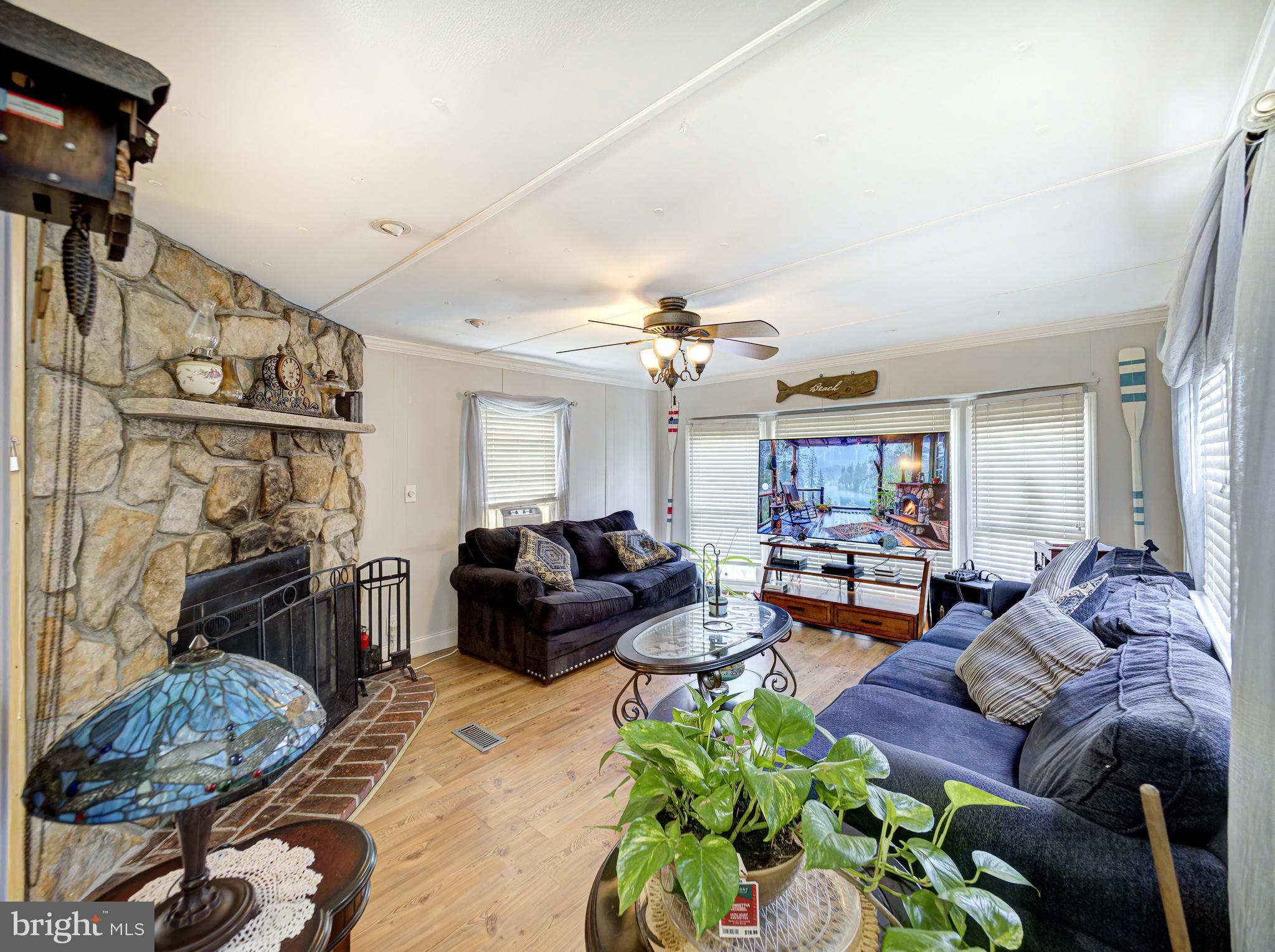 59 Bayshore Mobile Manor Hazlet, NJ 07730 - Photo 20 of 22 a living room with furniture and a fireplace