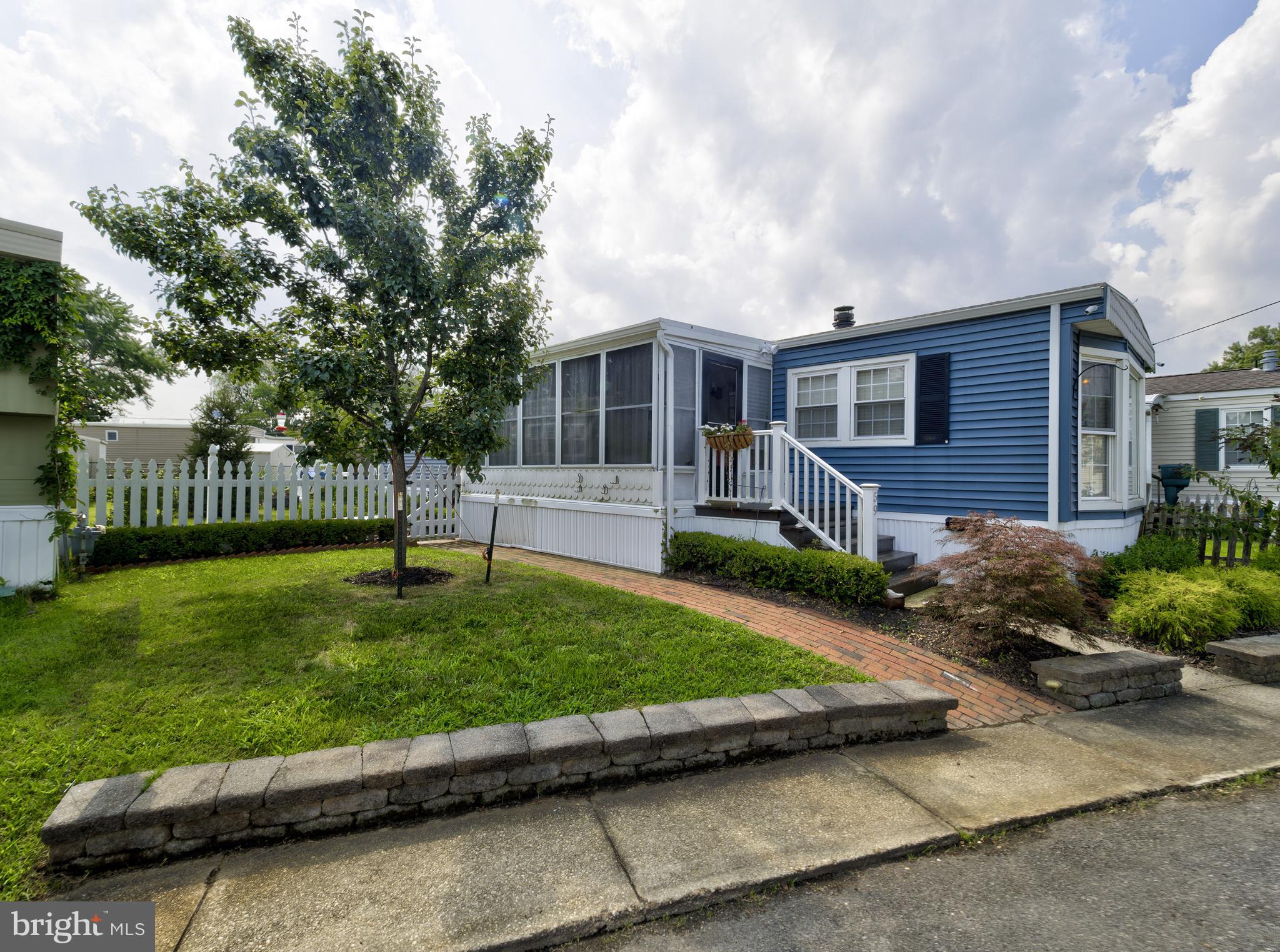 59 Bayshore Mobile Manor Hazlet, NJ 07730 - Photo 4 of 22 a front view of a house with a yard