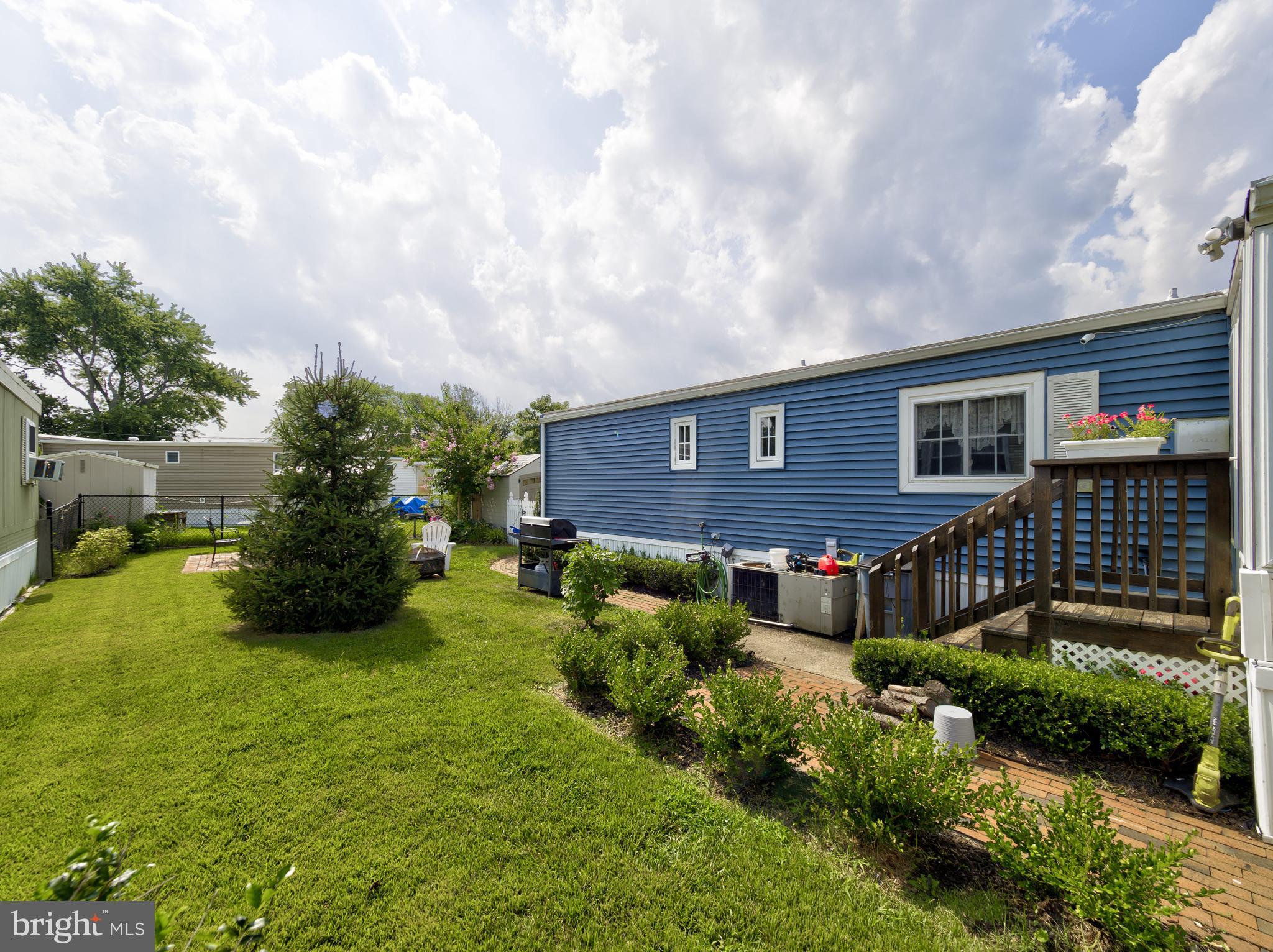 59 Bayshore Mobile Manor Hazlet, NJ 07730 - Photo 5 of 22 a front view of a house with a yard