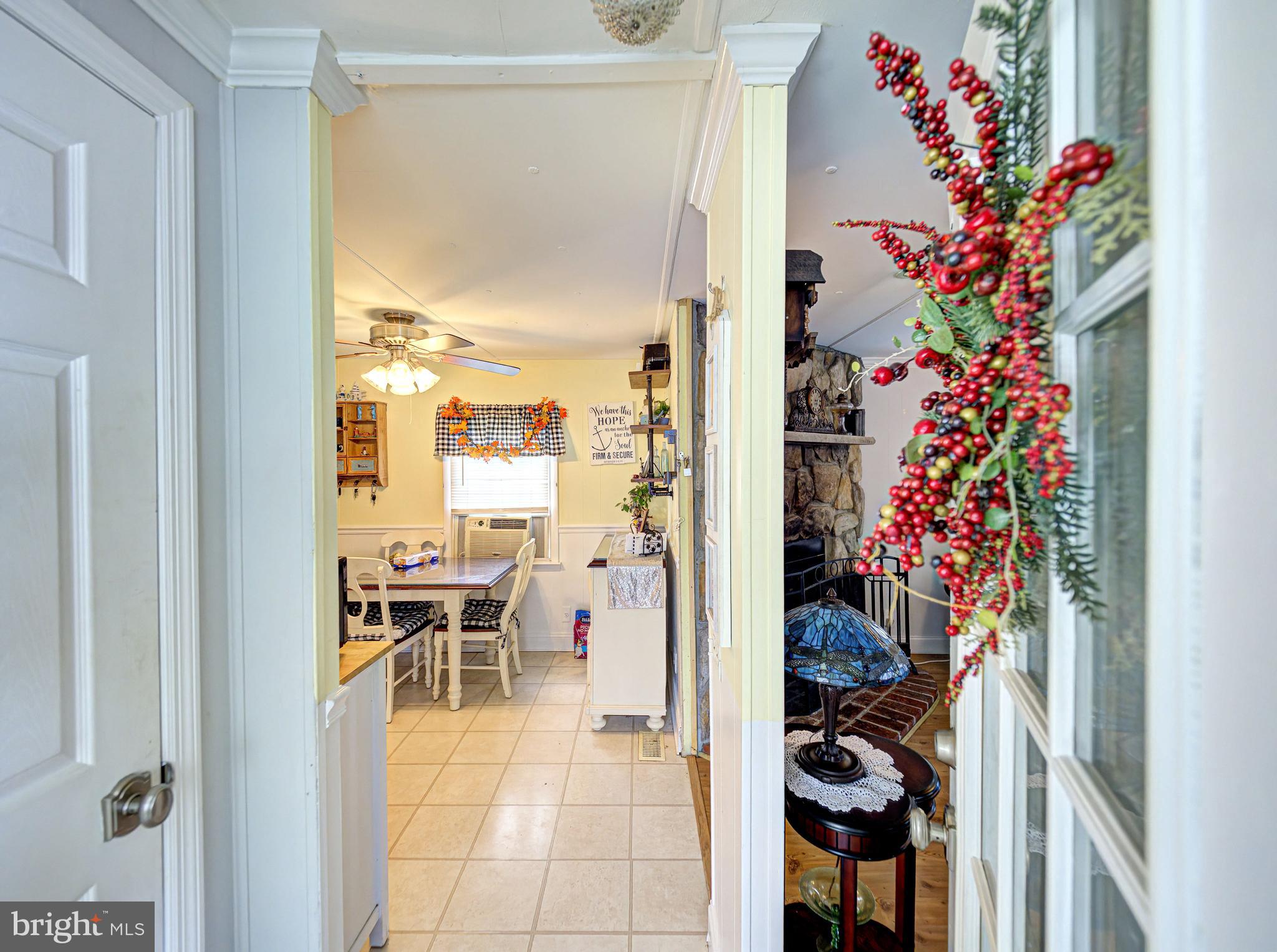 59 Bayshore Mobile Manor Hazlet, NJ 07730 - Photo 8 of 22 a view of a hallway and a dining table & chairs in a room