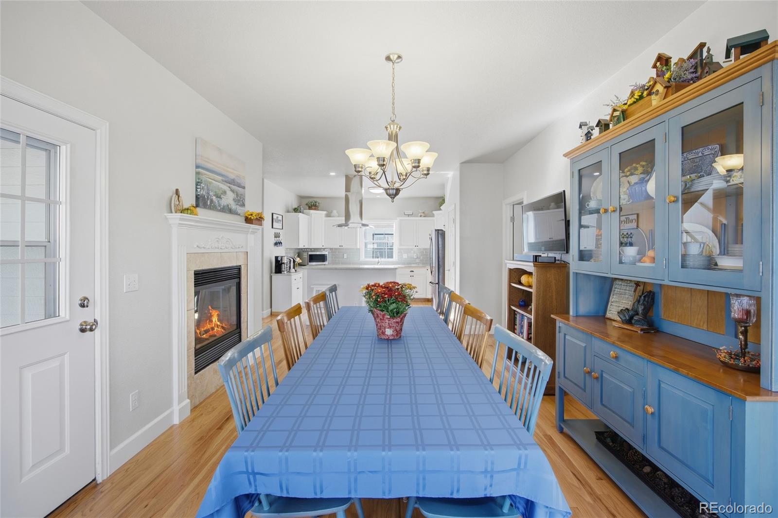 1229 Founders Circle Windsor, CO 80550 - Photo 11 of 45 a living room with fireplace furniture and a wooden floor