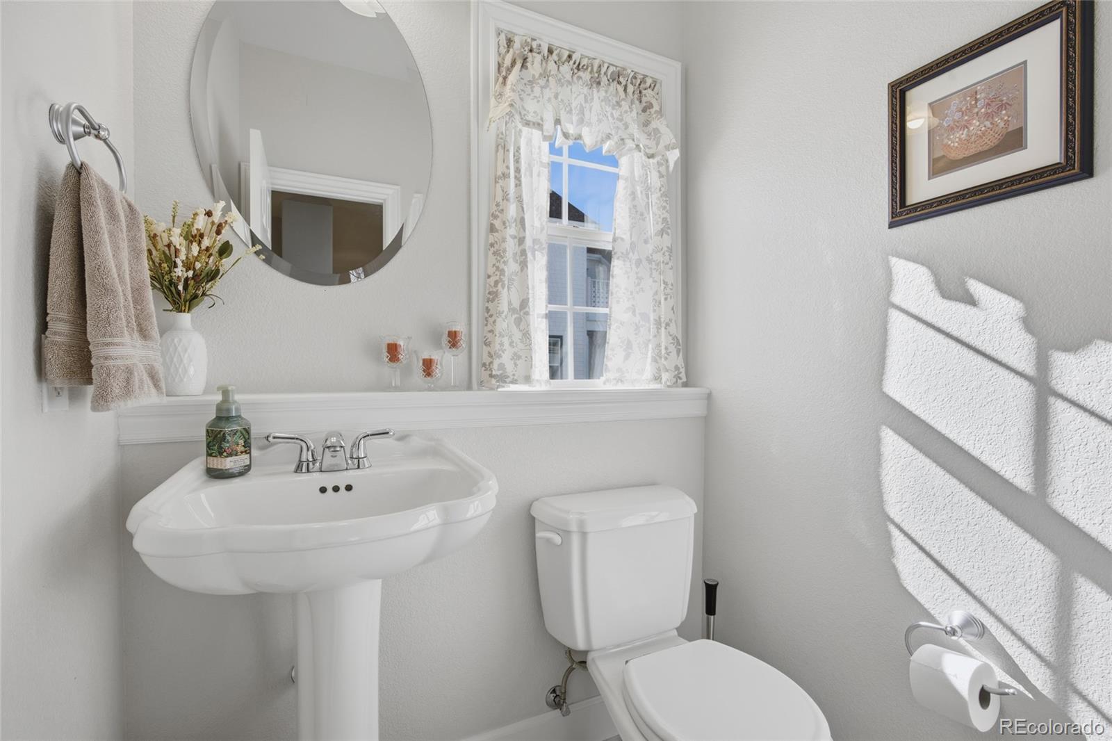1229 Founders Circle Windsor, CO 80550 - Photo 14 of 45 a bathroom with a toilet sink and mirror