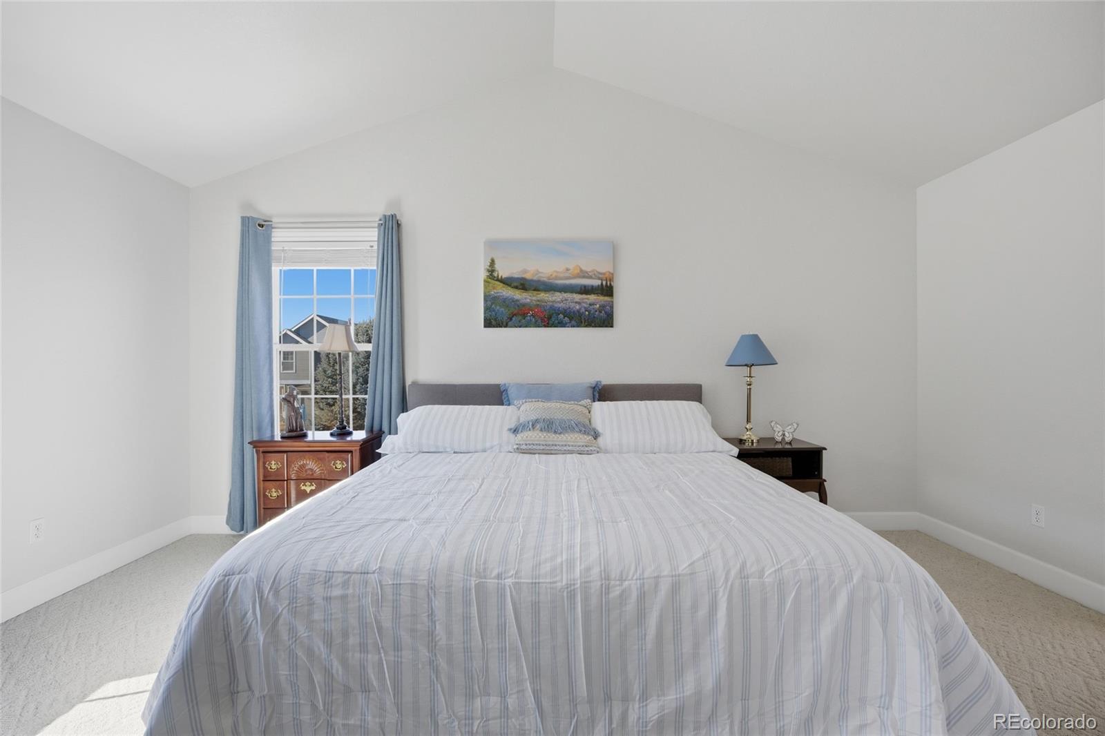 1229 Founders Circle Windsor, CO 80550 - Photo 17 of 45 a bedroom with a bed and a painting on the wall