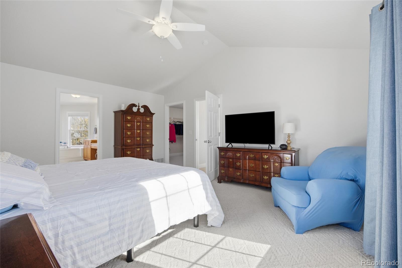 1229 Founders Circle Windsor, CO 80550 - Photo 18 of 45 a bedroom with bed and a flat screen tv