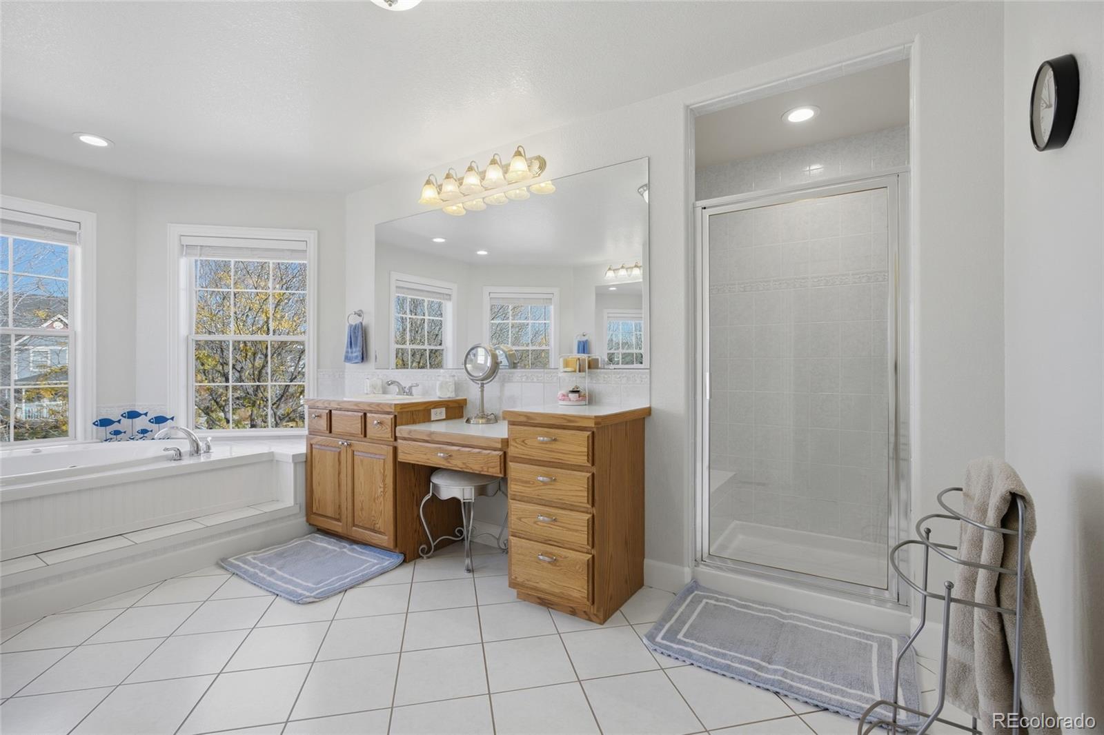 1229 Founders Circle Windsor, CO 80550 - Photo 19 of 45 a bathroom with a tub sink and a mirror