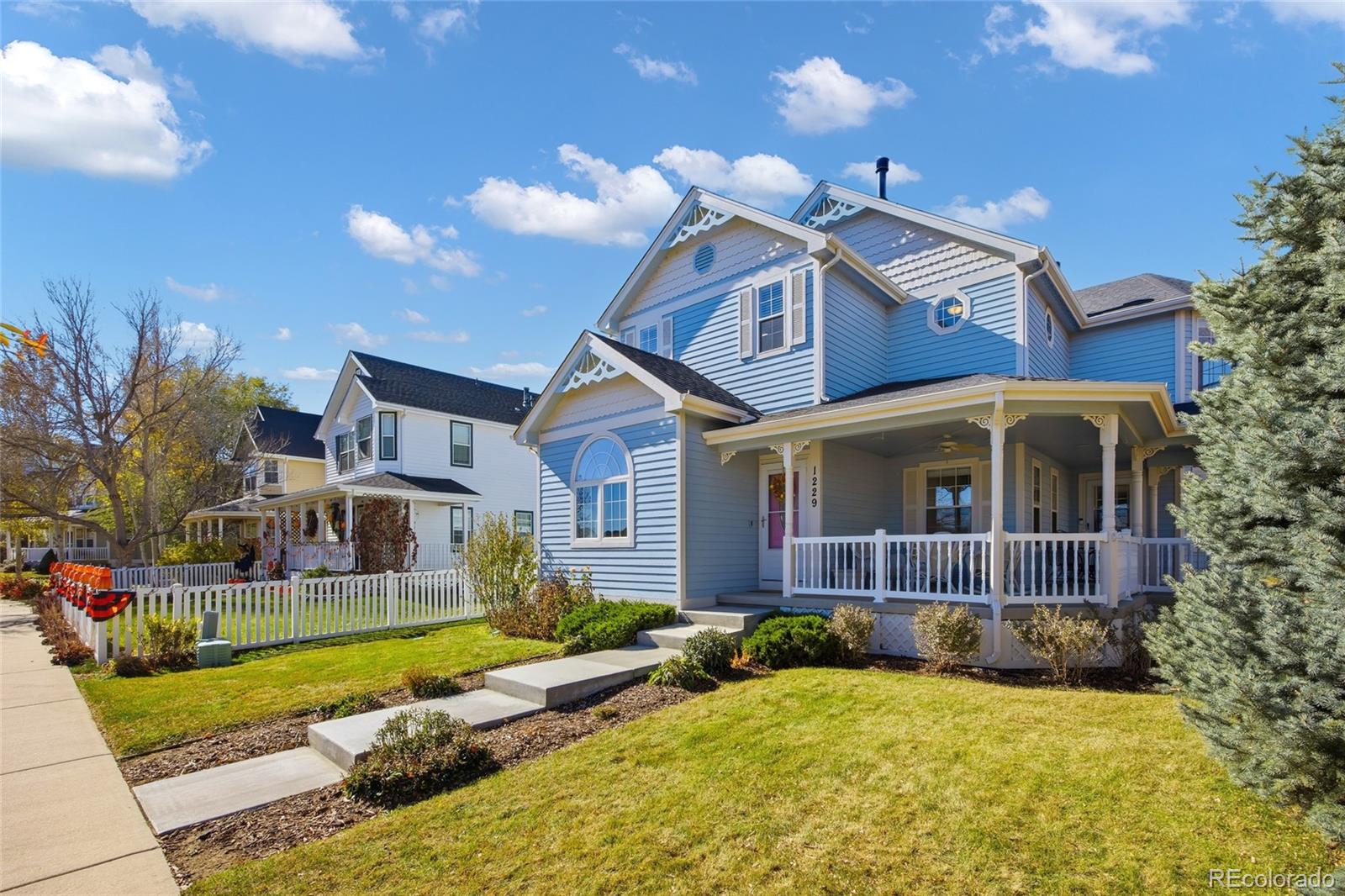 1229 Founders Circle Windsor, CO 80550 - Photo 2 of 45 a front view of a house with a yard balcony
