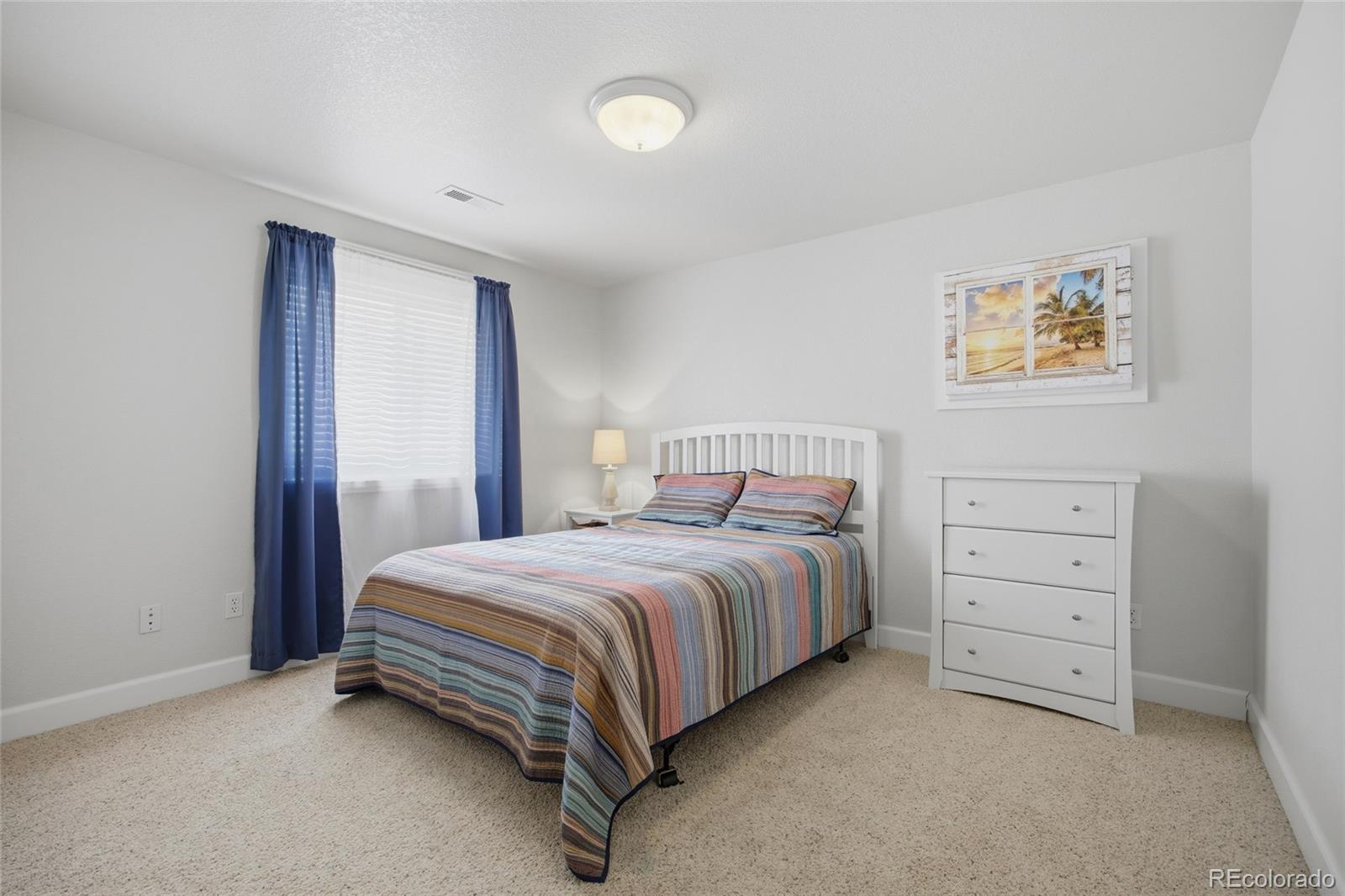 1229 Founders Circle Windsor, CO 80550 - Photo 30 of 45 a bedroom with a bed and a cabinets