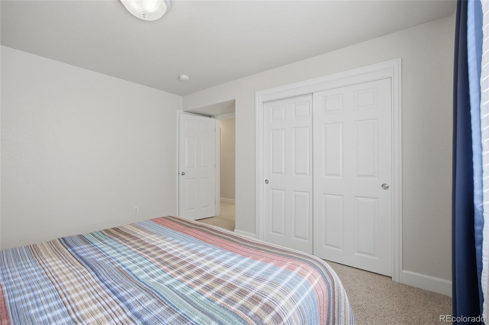 1229 Founders Circle Windsor, CO 80550 - Photo 31 of 45 a bedroom with a bed and a window