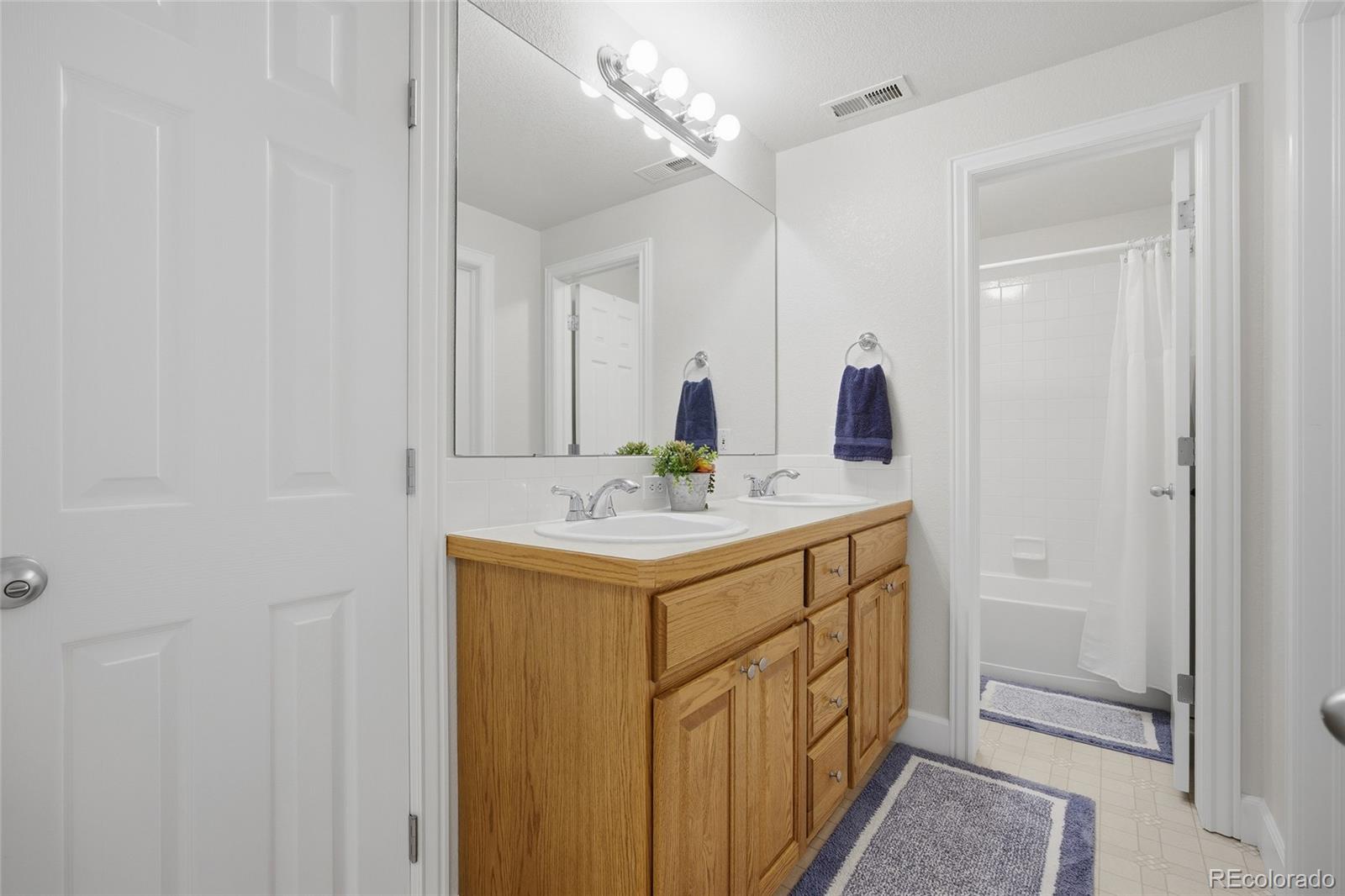 1229 Founders Circle Windsor, CO 80550 - Photo 32 of 45 a bathroom with a sink a vanity and a mirror