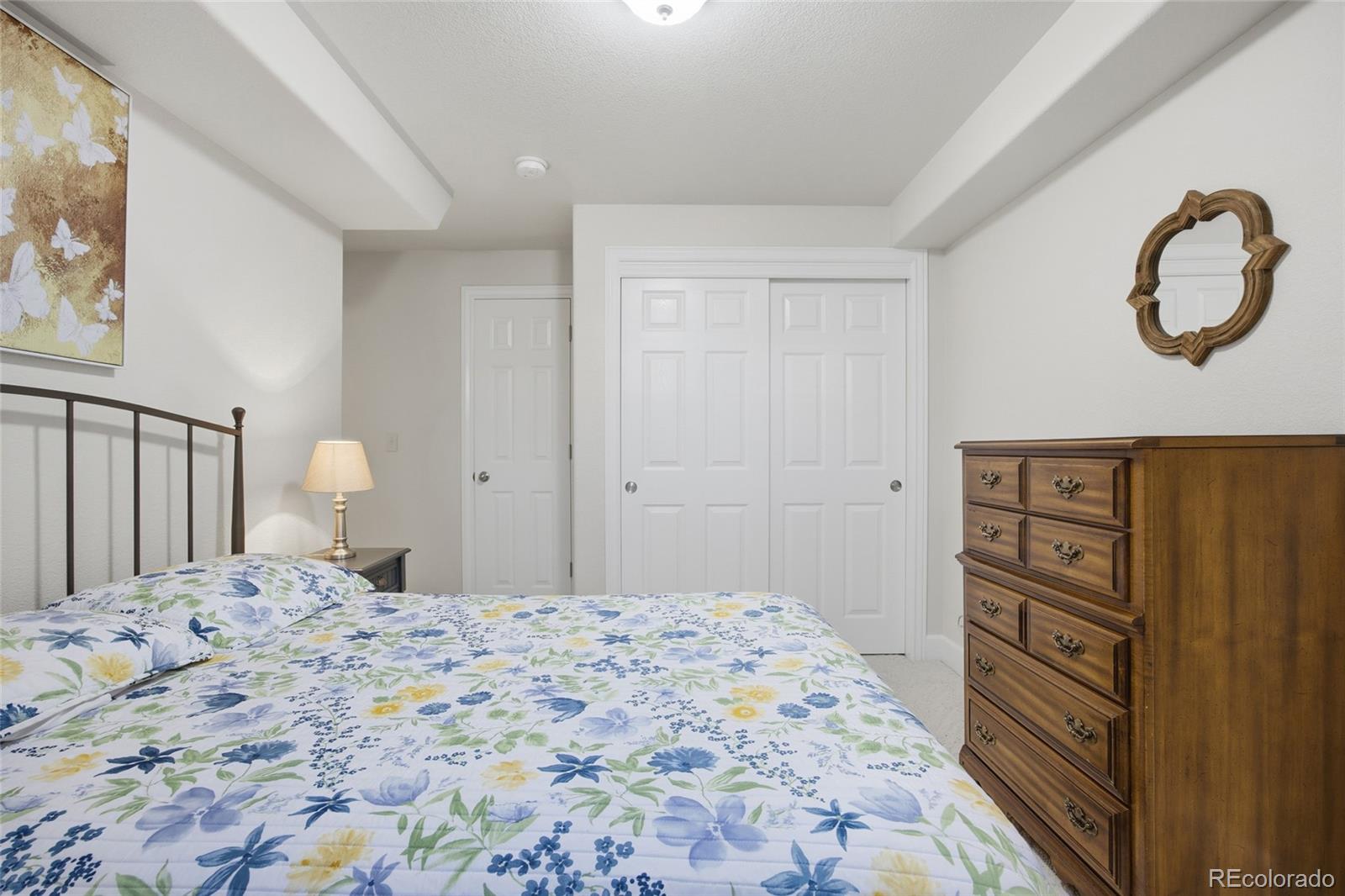 1229 Founders Circle Windsor, CO 80550 - Photo 34 of 45 a bedroom with a bed and a dresser