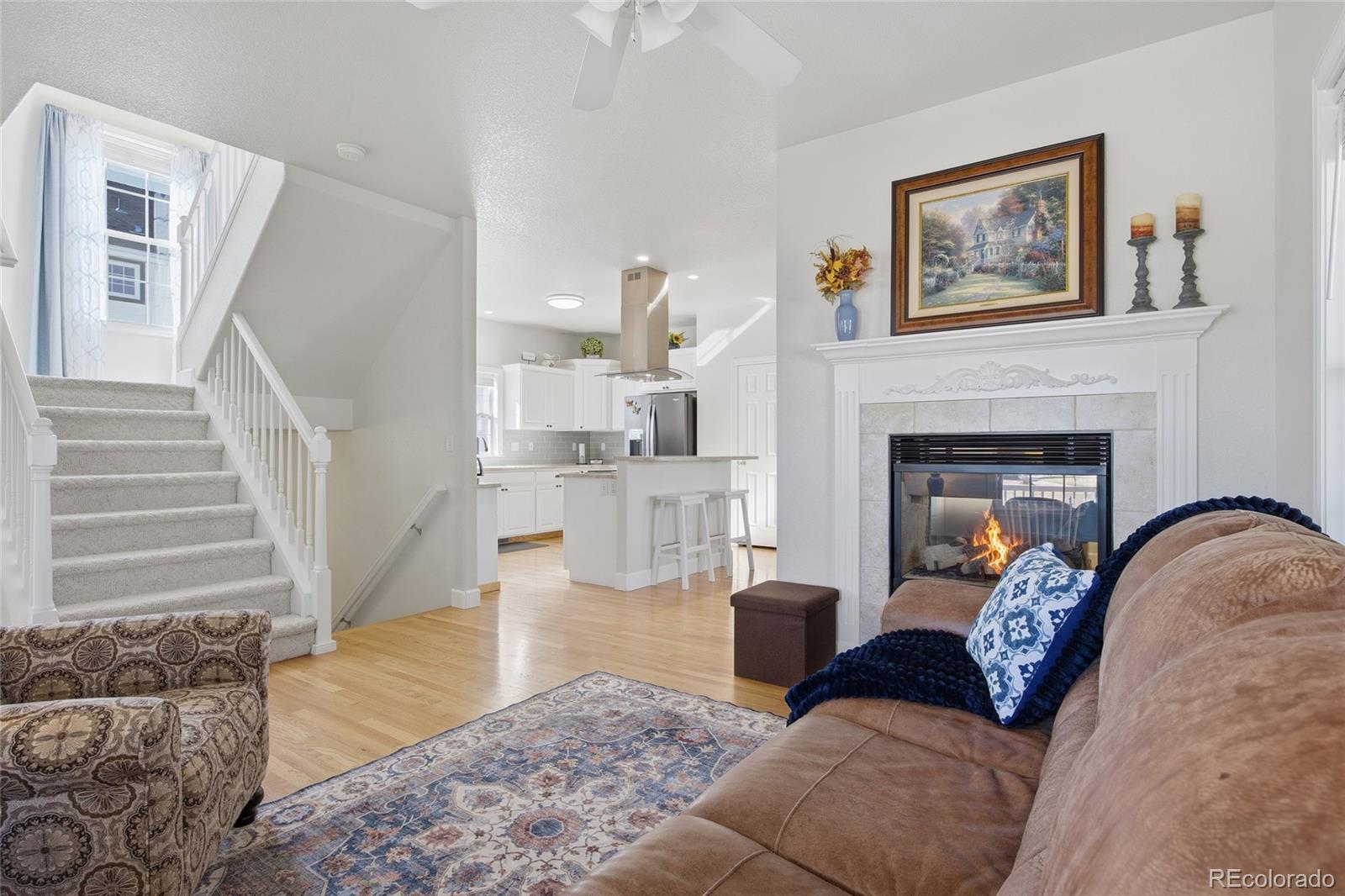 1229 Founders Circle Windsor, CO 80550 - Photo 4 of 45 a living room with furniture and a fireplace