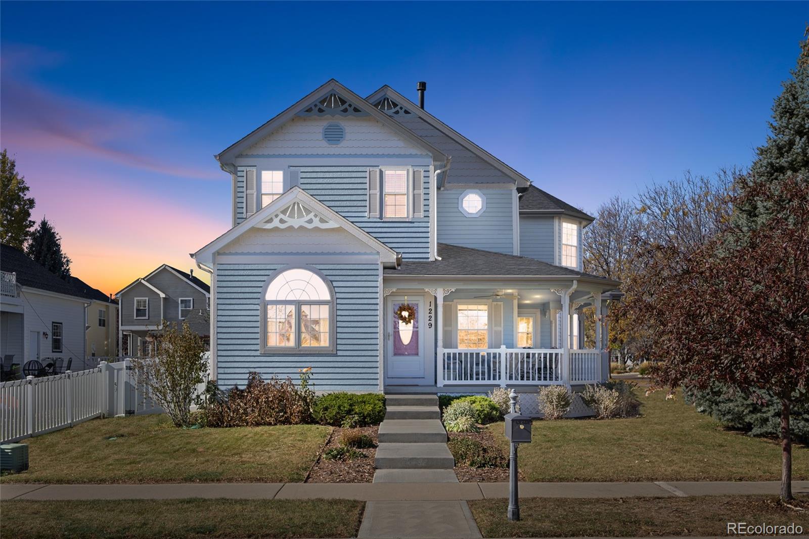 1229 Founders Circle Windsor, CO 80550 - Photo 44 of 45 a front view of a house with a yard