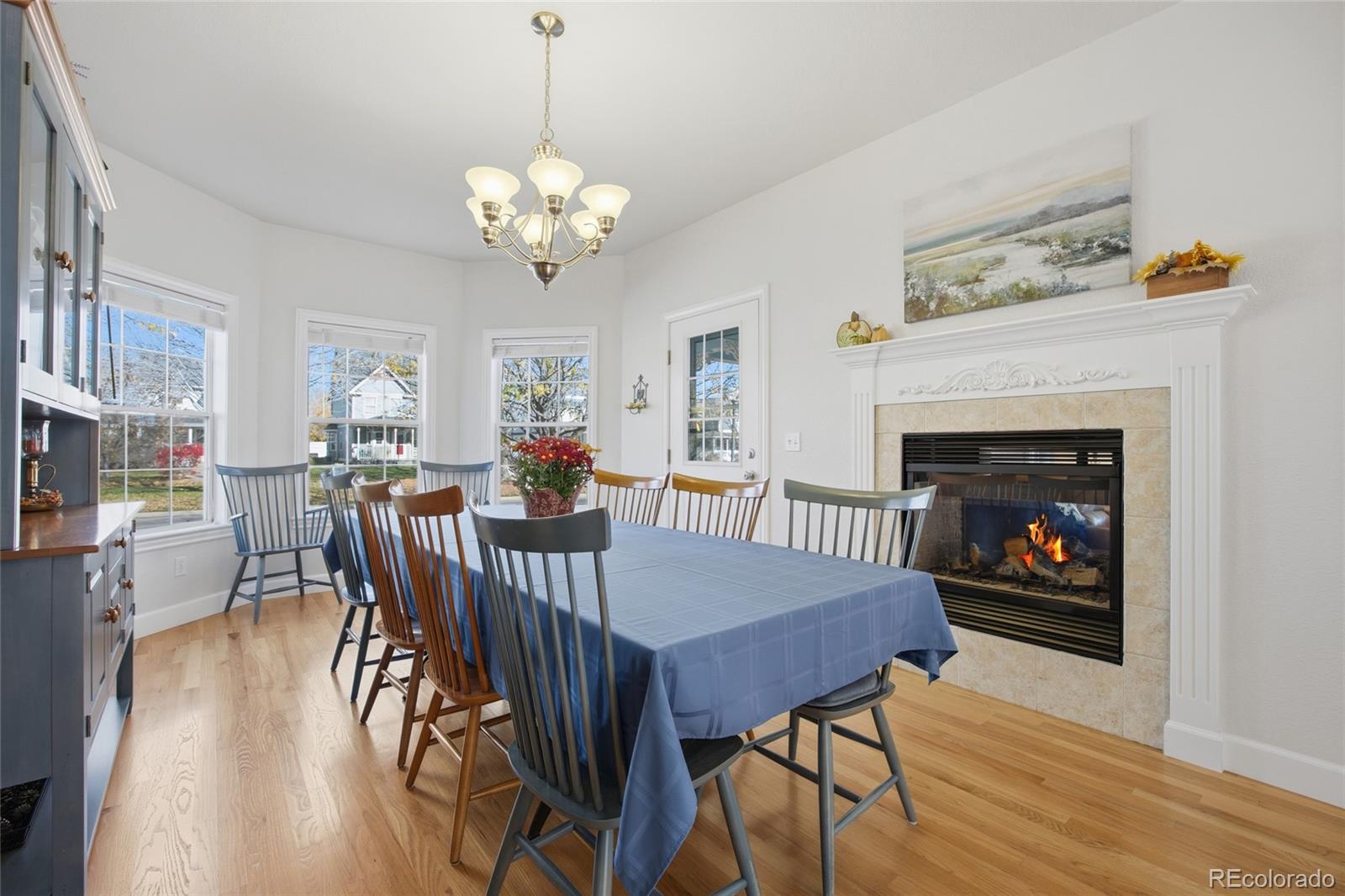 1229 Founders Circle Windsor, CO 80550 - Photo 10 of 45 a view of a dining room with furniture a chandelier and wooden floor
