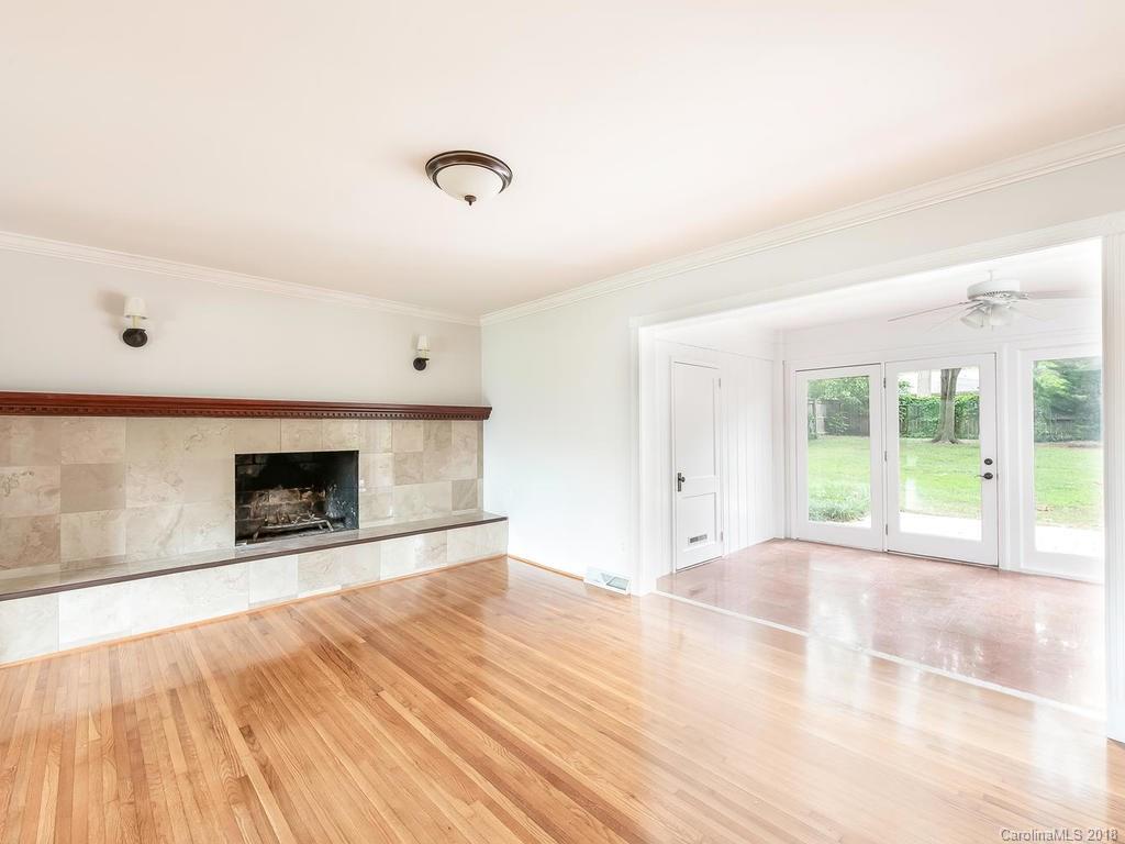 4801 Fairheath Road Charlotte, NC 28210 - Photo 11 of 25 a view of an empty room with a fireplace and a window