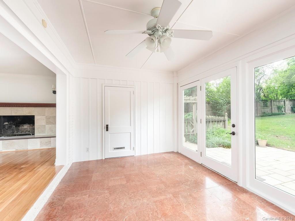 4801 Fairheath Road Charlotte, NC 28210 - Photo 12 of 25 a view of an empty room with a window and a kitchen
