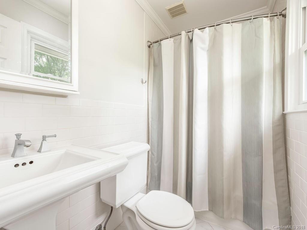 4801 Fairheath Road Charlotte, NC 28210 - Photo 16 of 25 a bathroom with a sink a toilet and shower curtain