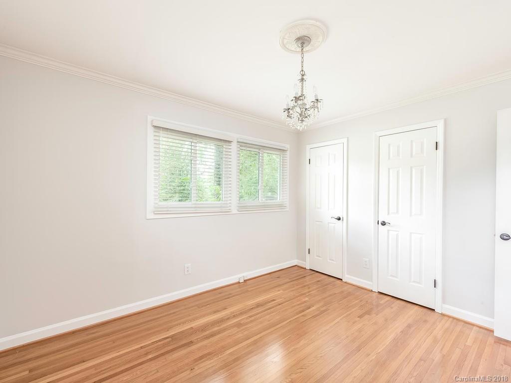 4801 Fairheath Road Charlotte, NC 28210 - Photo 19 of 25 wooden floor in an empty room with a window