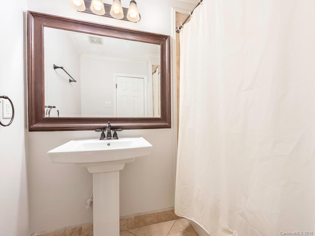 4801 Fairheath Road Charlotte, NC 28210 - Photo 20 of 25 a bathroom with a sink and a mirror