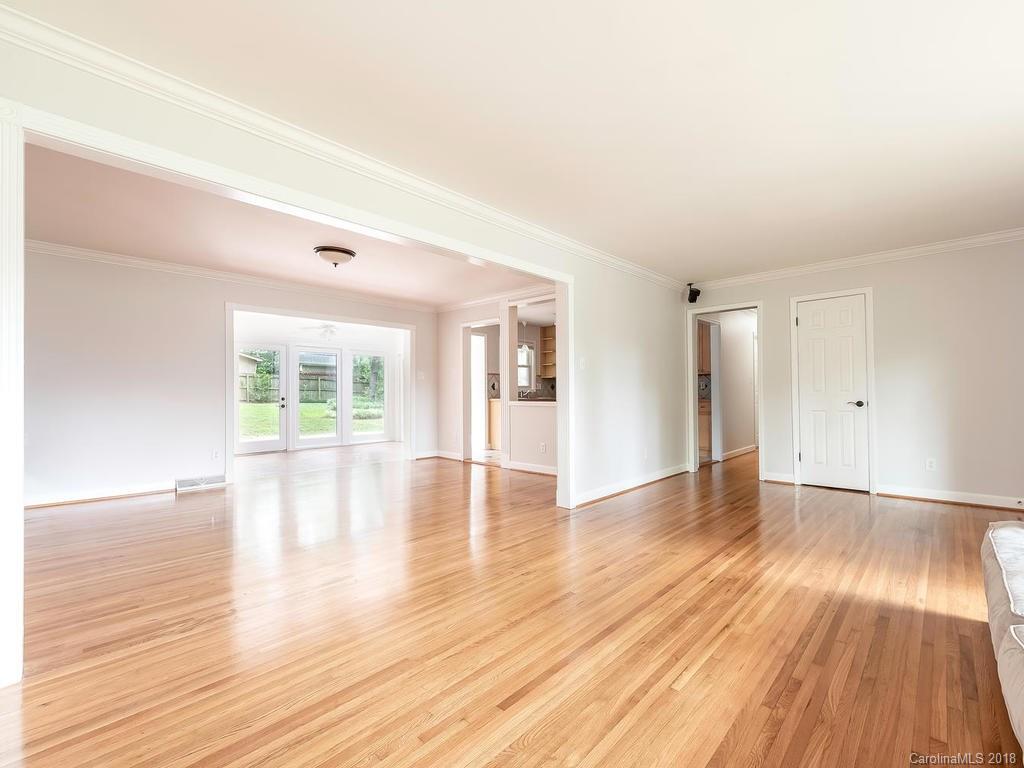 4801 Fairheath Road Charlotte, NC 28210 - Photo 4 of 25 a view of empty room with wooden floor and outer view