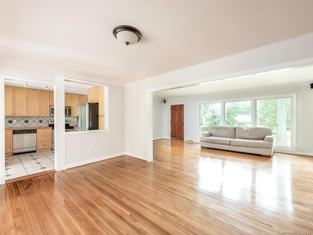 4801 Fairheath Road Charlotte, NC 28210 - Photo 6 of 25 a view of a living room filled with furniture and wooden floor