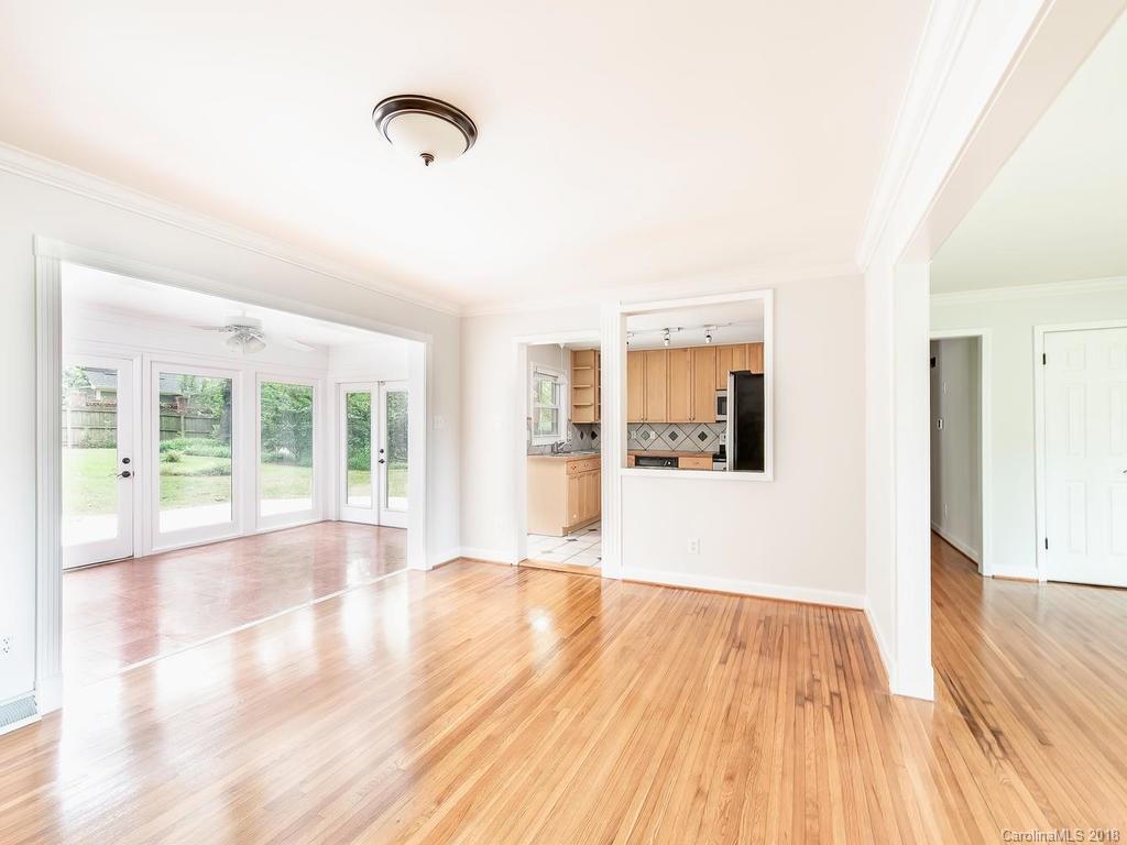 4801 Fairheath Road Charlotte, NC 28210 - Photo 7 of 25 a view of an empty room with wooden floor and a window
