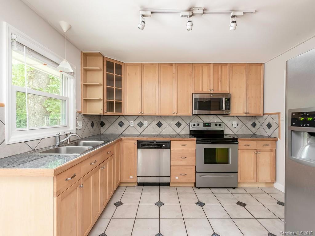 4801 Fairheath Road Charlotte, NC 28210 - Photo 8 of 25 a kitchen with stainless steel appliances granite countertop white cabinets granite counter tops and a window