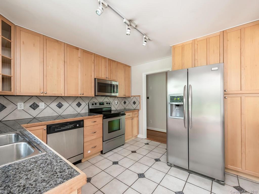 4801 Fairheath Road Charlotte, NC 28210 - Photo 9 of 25 a kitchen with stainless steel appliances granite countertop a refrigerator stove and sink