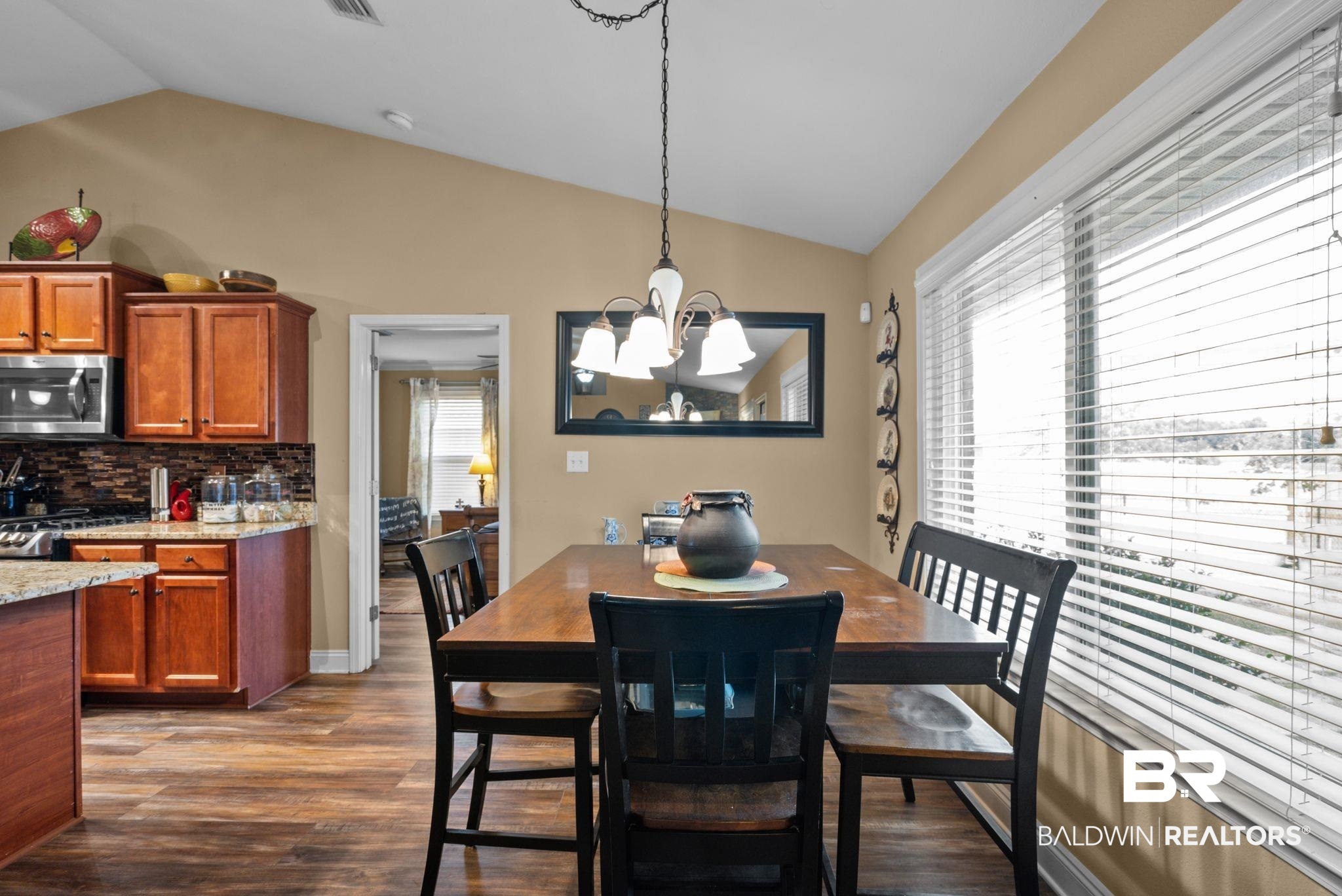 562 Vestige Mews Foley, AL 36535 - Photo 20 of 54 Vaulted ceiling dining area featuring wood-finish flooring and ample natural light from large windows