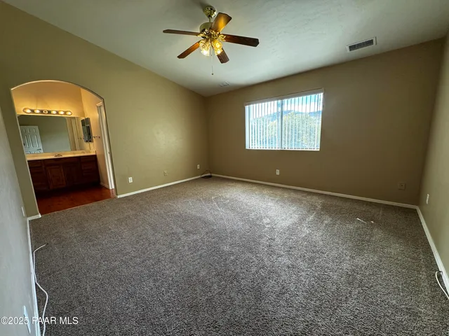 a view of empty room with a fireplace