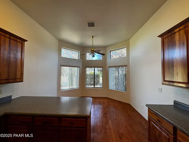 a view of a workspace with furniture and window