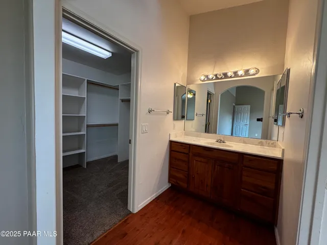a spacious bathroom with a double vanity sink and a mirror