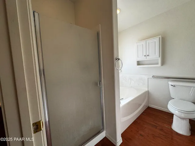 a bathroom with a toilet and a shower