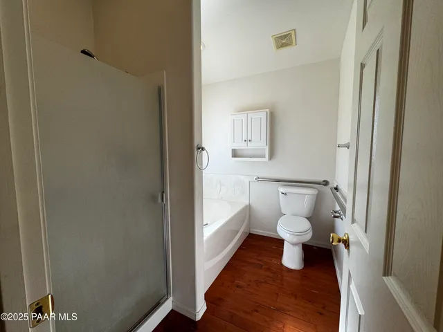 a bathroom with a toilet and a shower