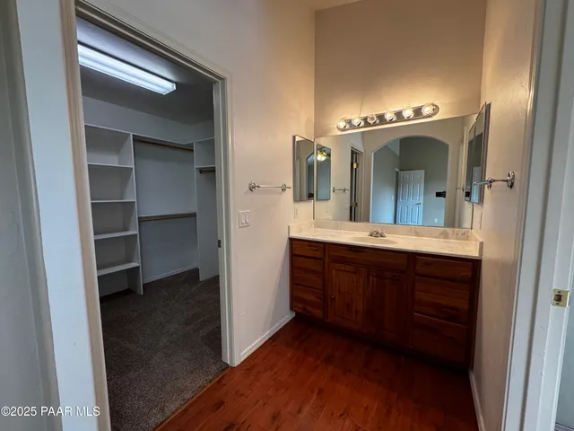 a spacious bathroom with a double vanity sink and a mirror