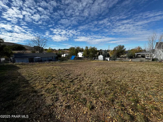 a view of a field of grass and a building