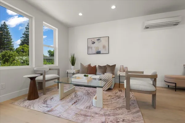 a living room kitchen with furniture and kitchen view