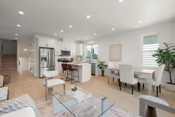 a dining room with furniture and a potted plant