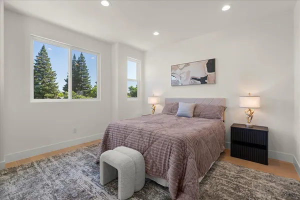 a bedroom with a bed and a potted plant