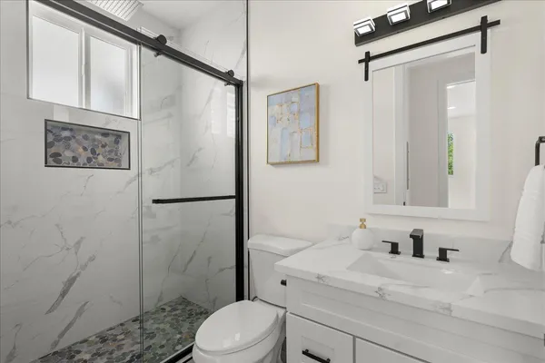 a view of a patio with table and chairs and a barbeque