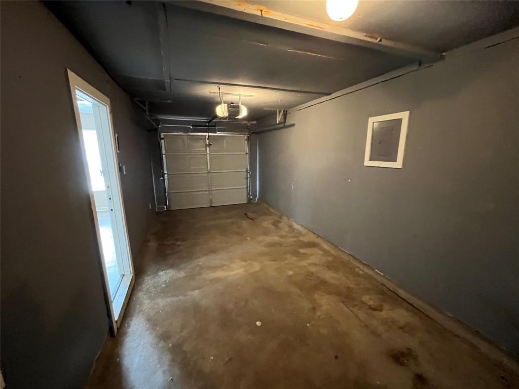 14207 Cimarron Drive Balch Springs, TX 75180 - Photo 20 of 23 Garage with a garage door opener and electric panel