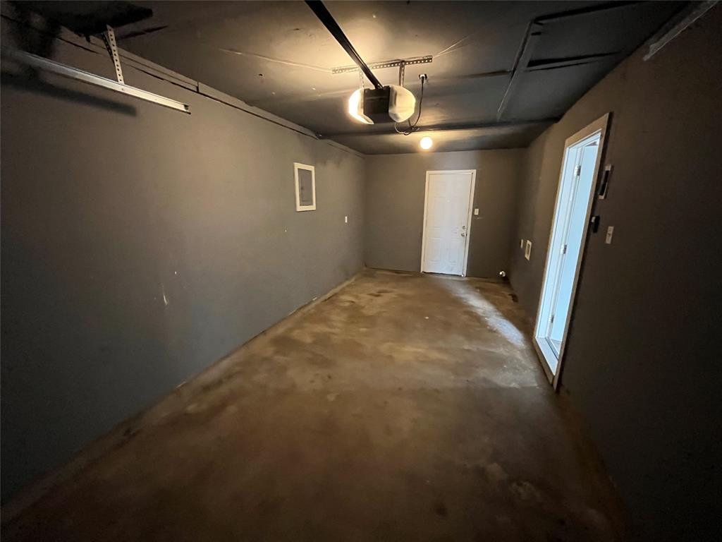 14207 Cimarron Drive Balch Springs, TX 75180 - Photo 21 of 23 Garage featuring a garage door opener