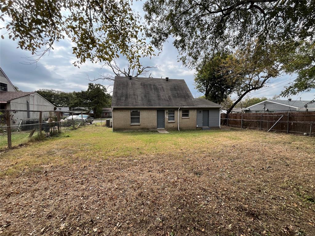 14207 Cimarron Drive Balch Springs, TX 75180 - Photo 23 of 23 Back of property featuring a fenced backyard, brick siding, and roof with shingles