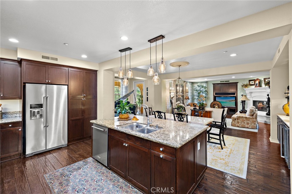 37 Tuscany Ladera Ranch, CA 92694 - Photo 14 of 53 a kitchen with a refrigerator a sink dishwasher a couches and chairs with wooden floor