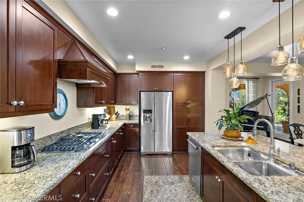 37 Tuscany Ladera Ranch, CA 92694 - Photo 15 of 53 a kitchen with stainless steel appliances granite countertop sink stove refrigerator and cabinets